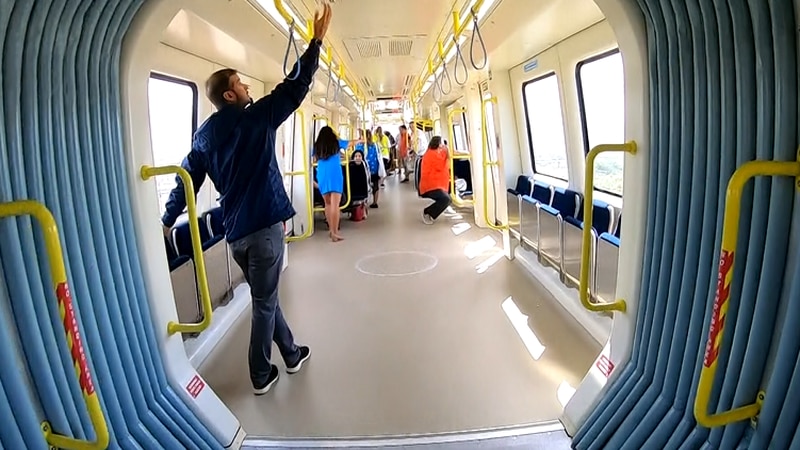 Passengers ride the Skyline, the city's new rail system.