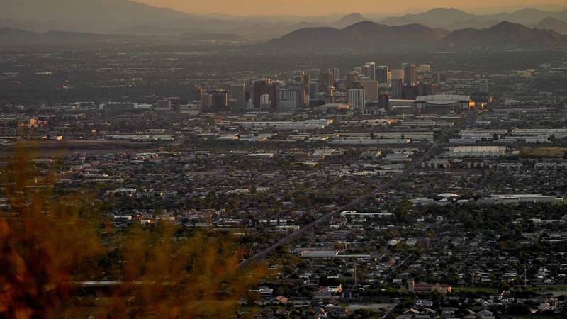Day breaks over downtown Phoenix, Monday, July 17, 2023. Phoenix is set to break its own record...