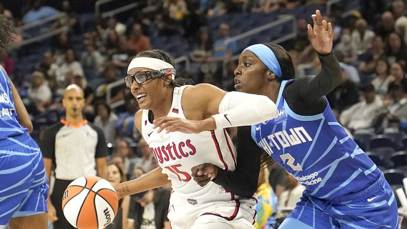 Washington Mystics' Brittney Sykes (15) drives as Chicago Sky's Kahleah Copper defends during a...