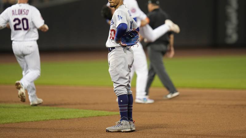 Los Angeles Dodgers' Mookie Betts, center front, reacts after New York Mets' Luis Guillorme hit...