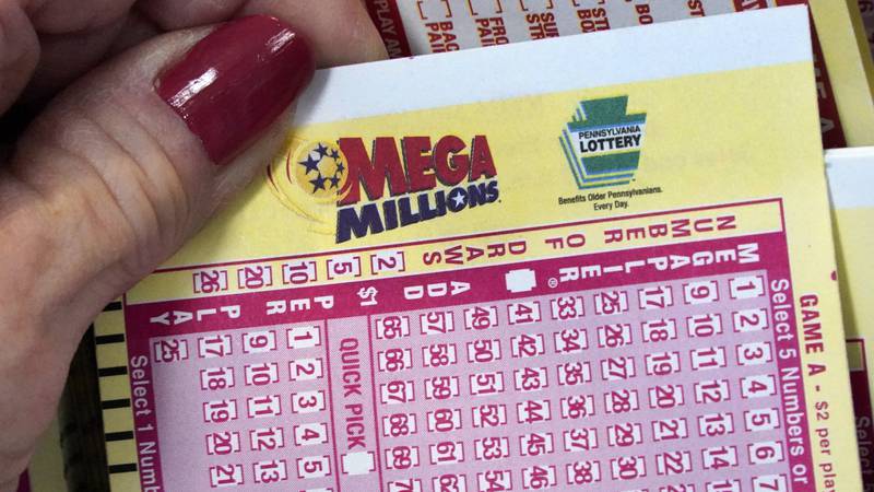 FILE - A Mega Millions wagering slip is held in Cranberry Township, Pa., Jan. 12, 2023. The...